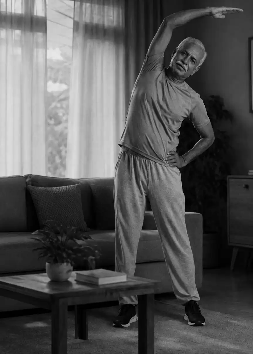 Older man doing a stretching exercise at home during a guided fitness session