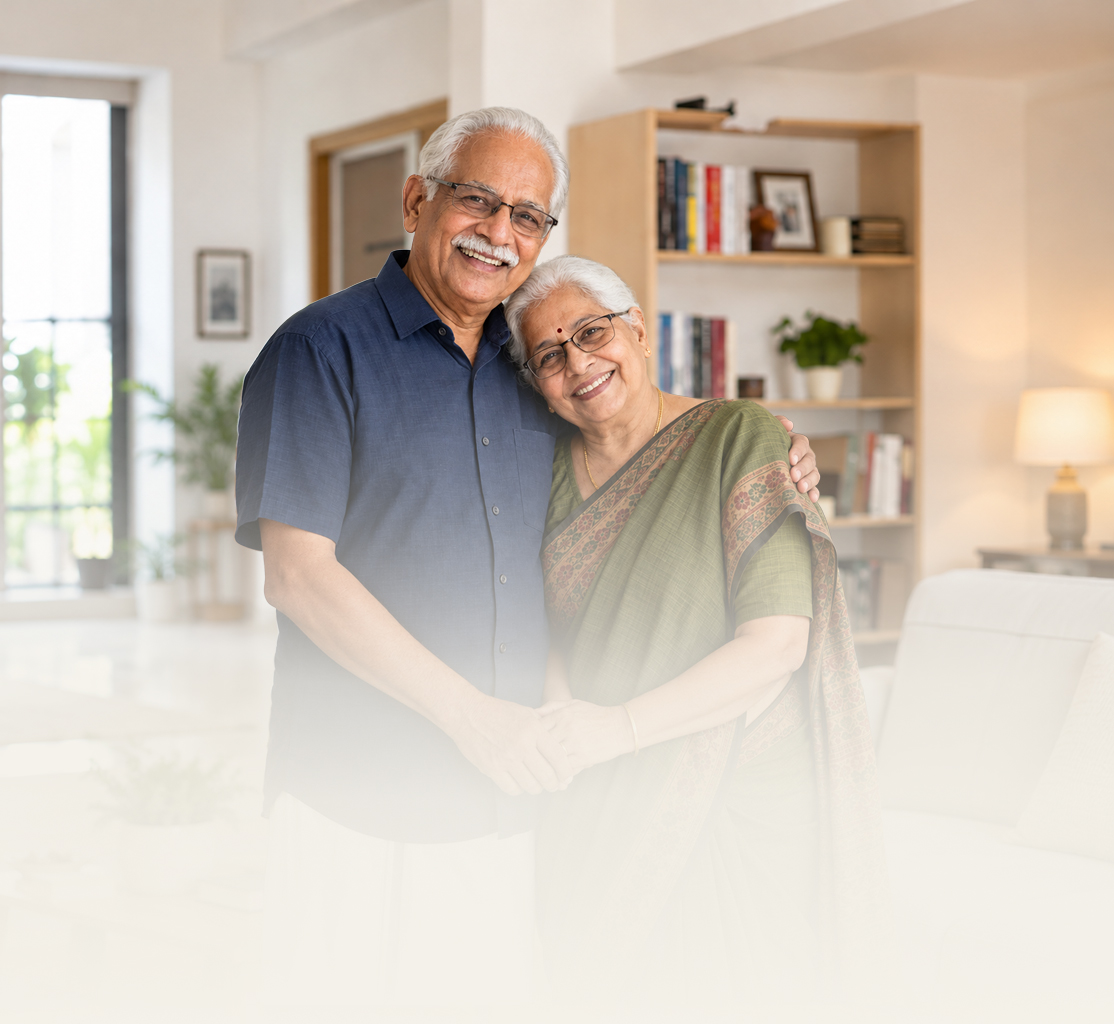 Smiling elderly Indian couple walking arm-in-arm outdoors, representing healthy ageing
